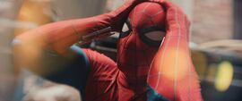 Spider- holds his head in shock