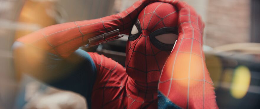 Spider- holds his head in shock