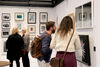 People looking at prints hanfging on teh wall of Centrespace