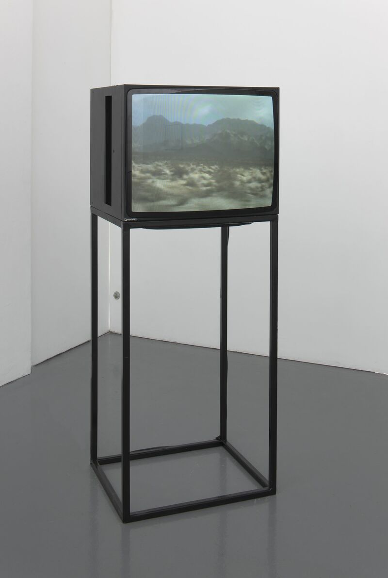 From Cara Tolmie's exhibition. A large, old television displays an image of a desert with shrubs and mountains in the background.