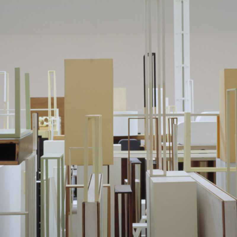 An image from Nahum Tevet/Ergin Çavuşoğlu's exhibition shows a room filled with plywood structures, some of them are narrow, hollowed out frames, and some are flat blocks. They are all white, beige or brown in colour.