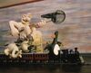 Wallace and Gromit chase the penguin Feathers McGraw on their high speed train set. Wallace holds a fishing net