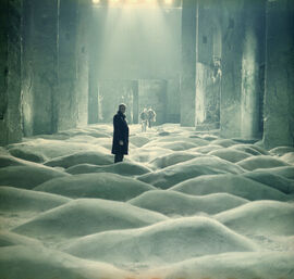 Three men in a strange undulating room