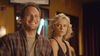 A blonde women gives a smiling man the side eye