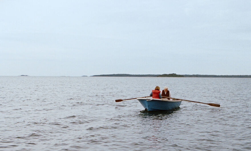 A girl and her grandmother in a rowing boat on the sea