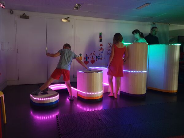 Children and adults playing on Soundplays Signwave installation