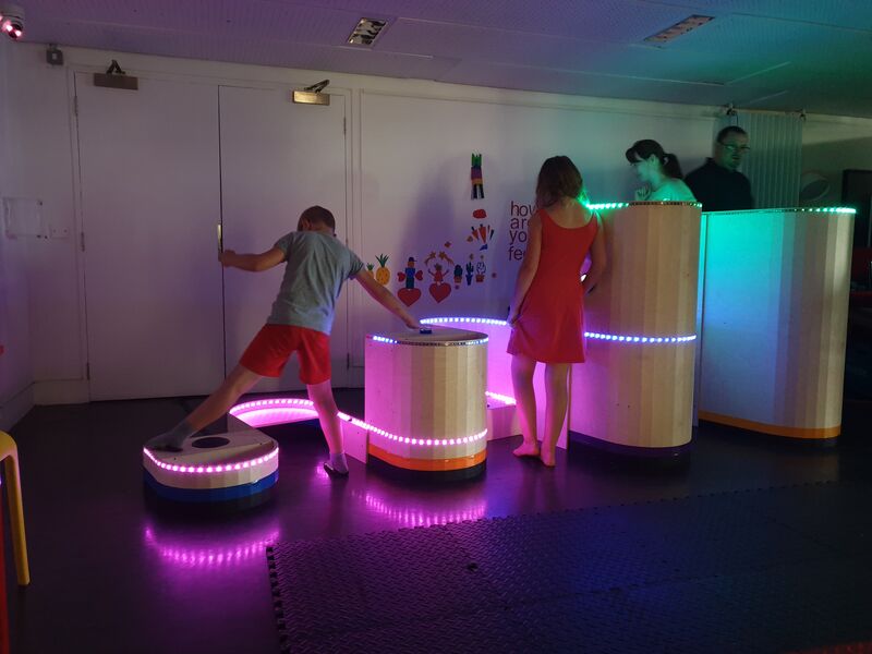 Children and adults playing on Soundplays Signwave installation