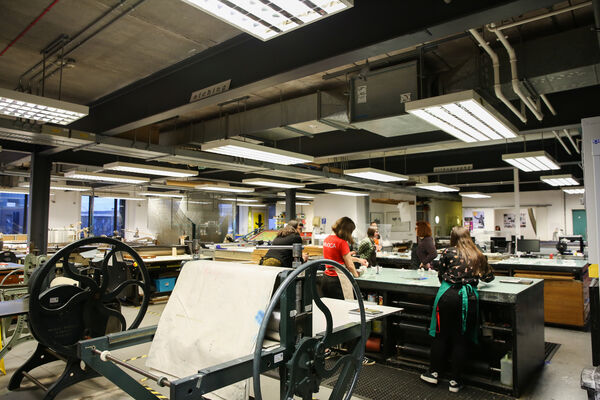 People working at different tables in DCA Print Studio