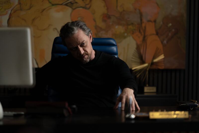 James Mcavoy behind a desk, gesturing