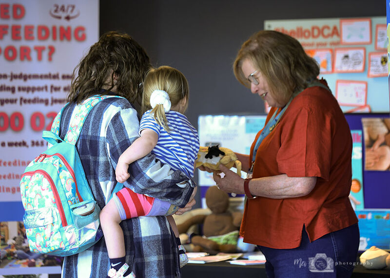 Parent and child talking to a stallholder
