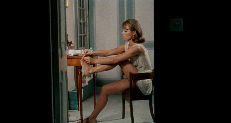 A woman paints her toenails