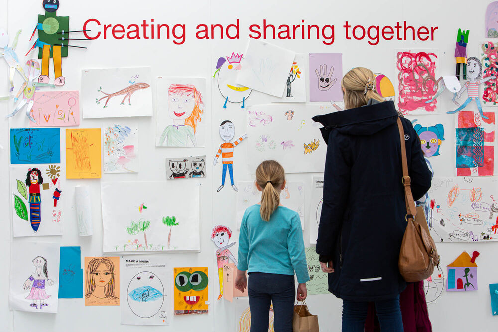 Adult and child looking at drawings