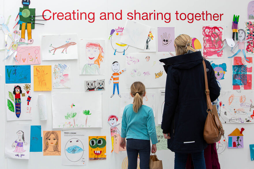 Adult and child looking at drawings