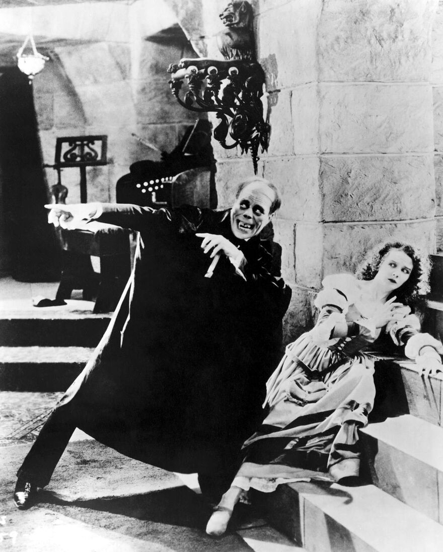 A man points while a woman looks afraid