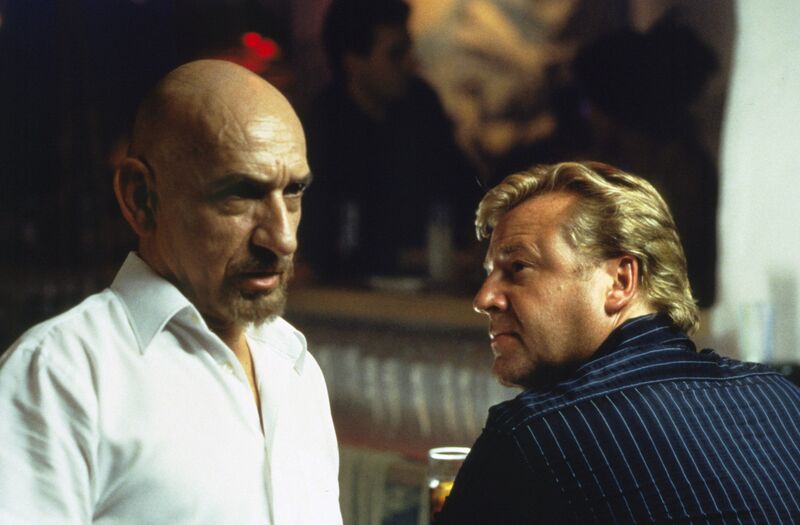 Ben Kingsley and Ray Winston talk seriously in the dark