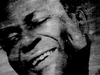 A slightly hazy image of a Black man with his eyes closed and head tilted