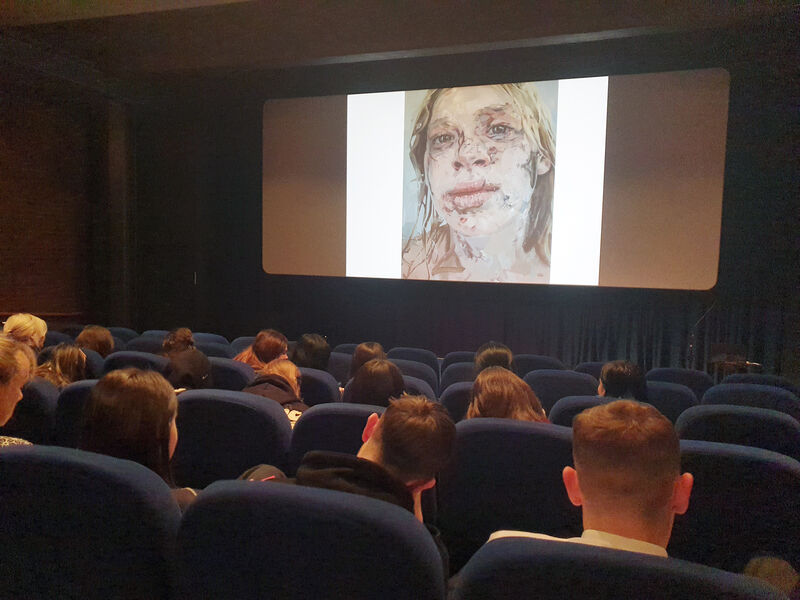 secondary school pupils in DCA cinema looking at a portrait on the screen