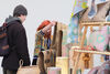 Maker showing a textile to someone at their stall