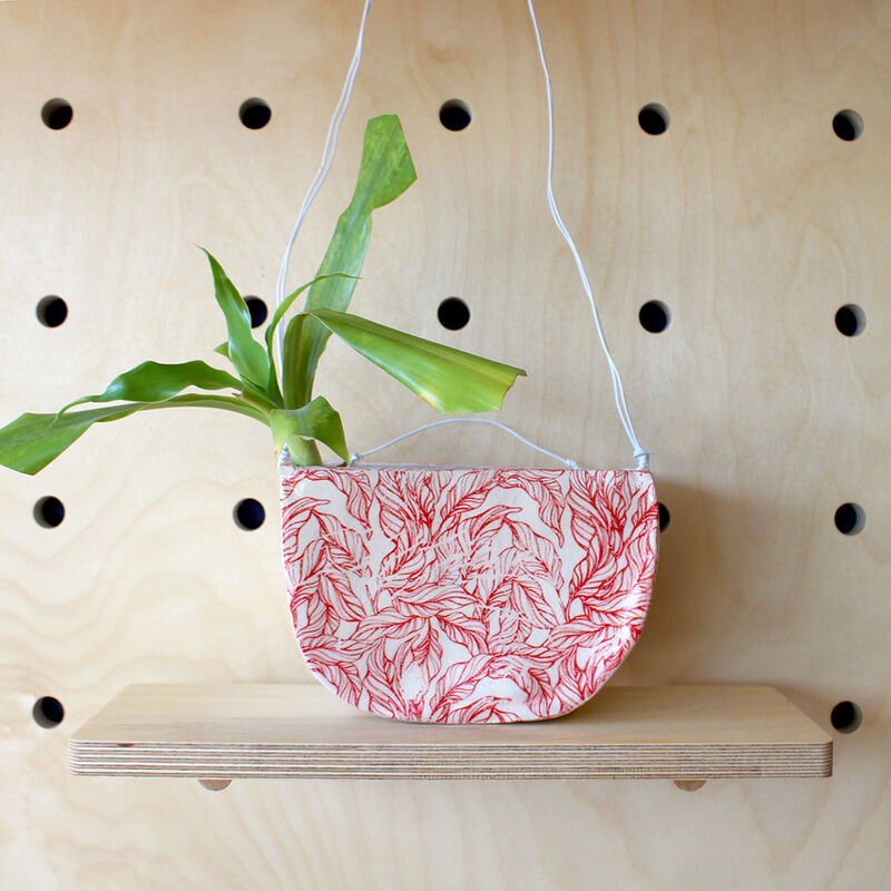 Ceramic hanging planter with red leaf design