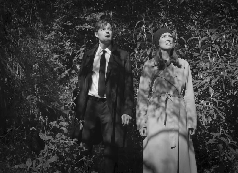 Black and whitetill from Bulk of a man and a woman standing outside