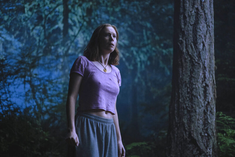 Woman standing in the woods