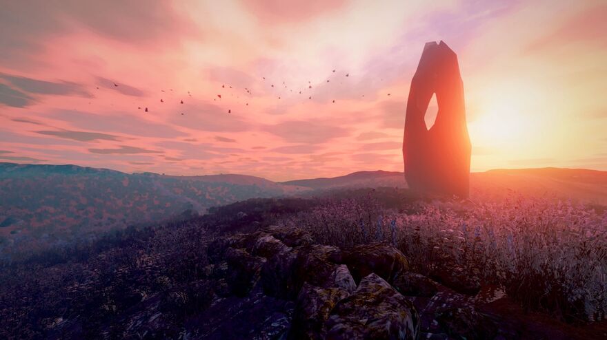 A singular, curved rock formation stands in a field of heather as the sun rises.