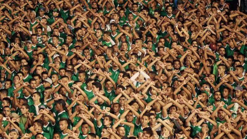 Stadium crowd with crossed arms