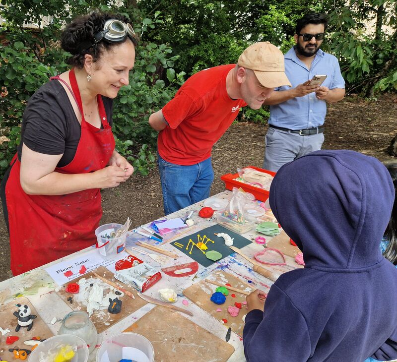 Table with clay and children making models of bugs