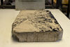 Close up of limestone slab with inked image of a landscape on it