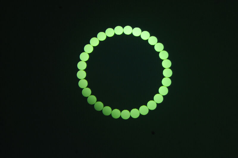 From Jaygo Bloom's exhibition. An outline of a circle on a black background is made up of smaller, filled in green triangles.
