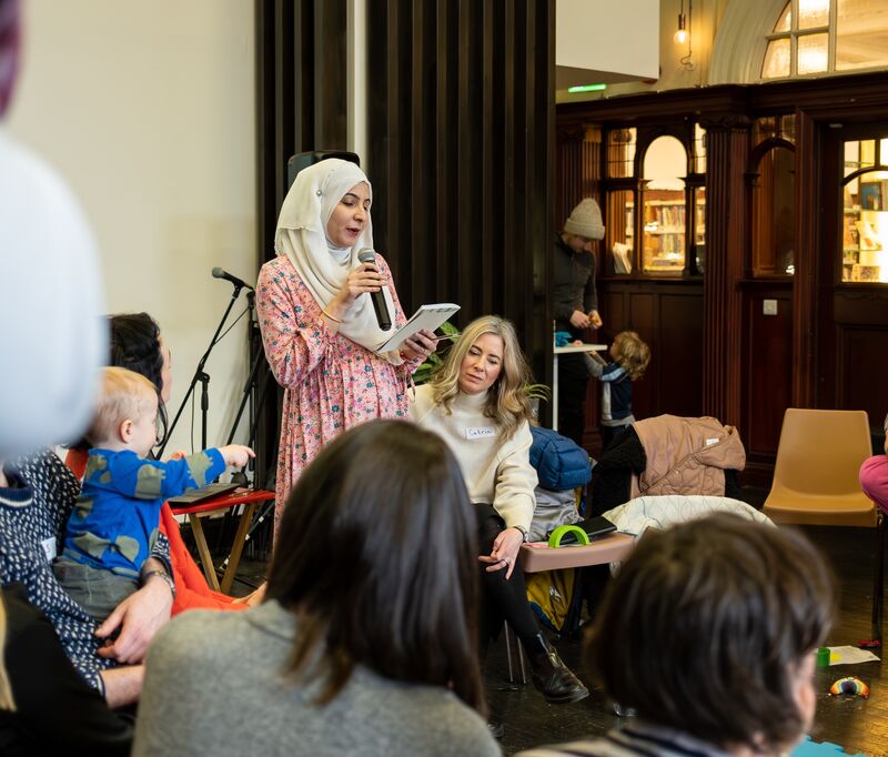 A women wearing a headscarf talks on the microphone