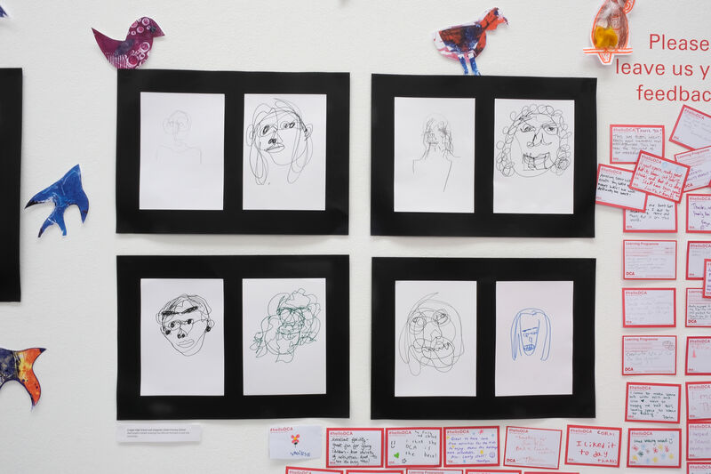 Wall with continuous line portraits