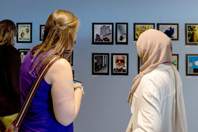 people looking at images on the wall of Create Space