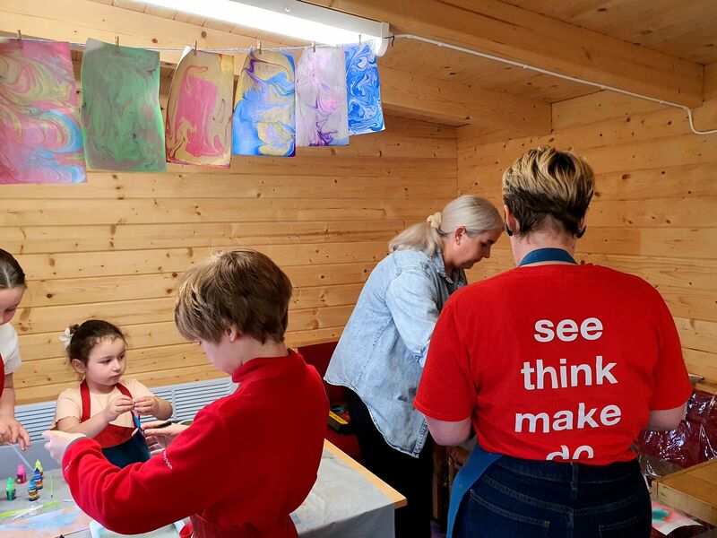 Familis and DCA staff creating marbled paper