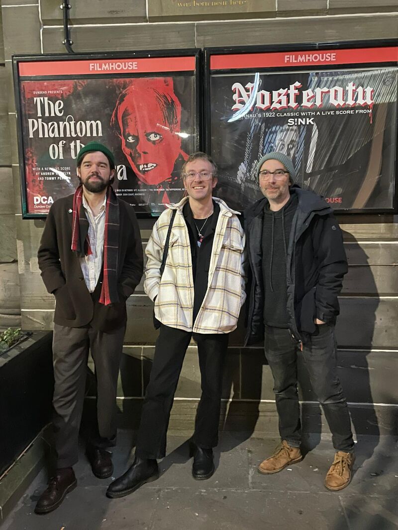  Andrew Wasylyk, Michael Coull and Tommy Perman standing in front of The Phantom of the Opera poster displayed outside of Filmhouse E=dinburgh