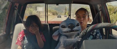 An alien takes the wheel of a car driven by a woman and her young sister
