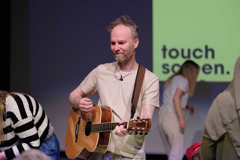 A person plays the guitar in an interactive cinema experience