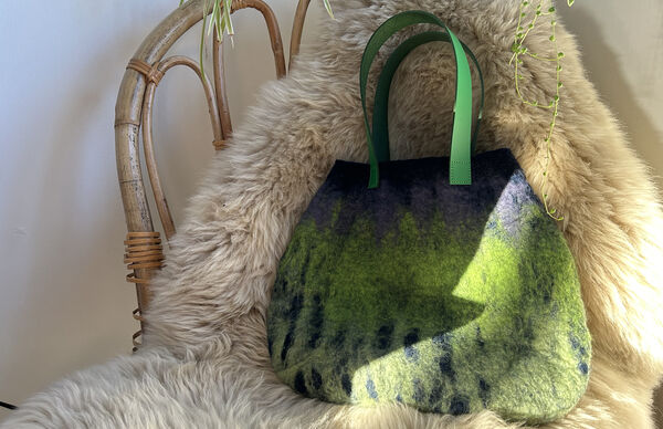 Hand felted handbag made with green and blue felt with green leather straps