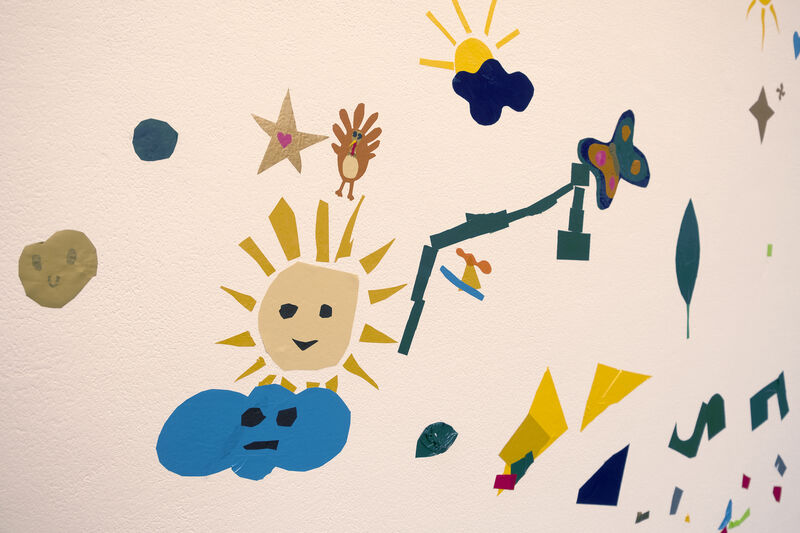 Vinyl artwork on the wall including a happy sunshine, cloud and turkey