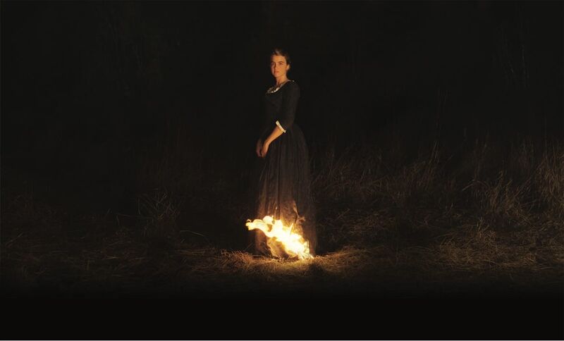 a woman stands, her long historical dress is on fire.