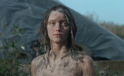 Girl standing outside covered in dirt