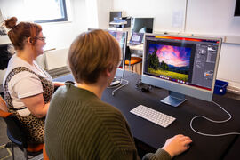 Person working on Photoshop using a Mac