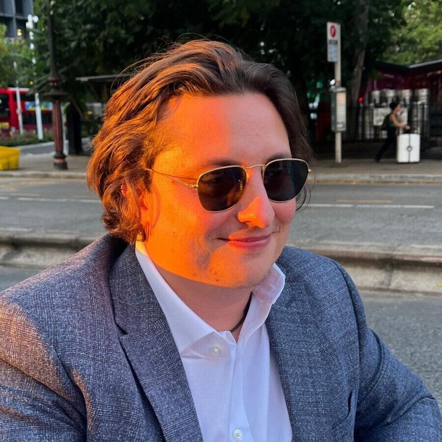 A photo of Alec Morana, a man wearng sunglasses and a suit