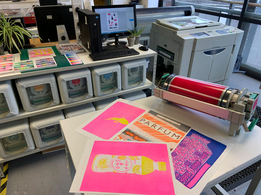 Riso printing machine in DCA Print Studio surrounded by computer ink drums and riso prints