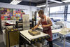 Calujm Wallis wetting a stone with sponge while printing using stone lithography