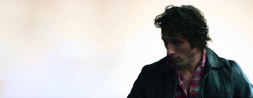 Jeremy Allen White wearing a leather jacket as Bruce Springsteen.