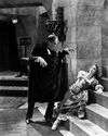 Lon Chaney as The Phantom of the Opera standing over a woman on the stairs