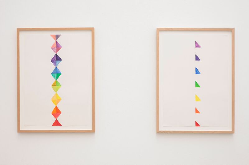 Framed drawings from Katy Dove's exhibition show triangles drawn with felt-tips, arranged in a rainbow pattern.