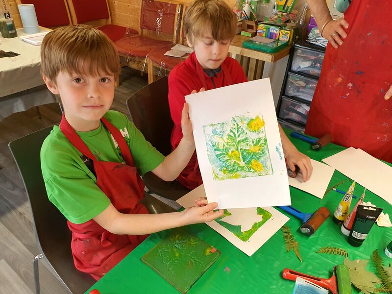 Child showing their leaf gelli print