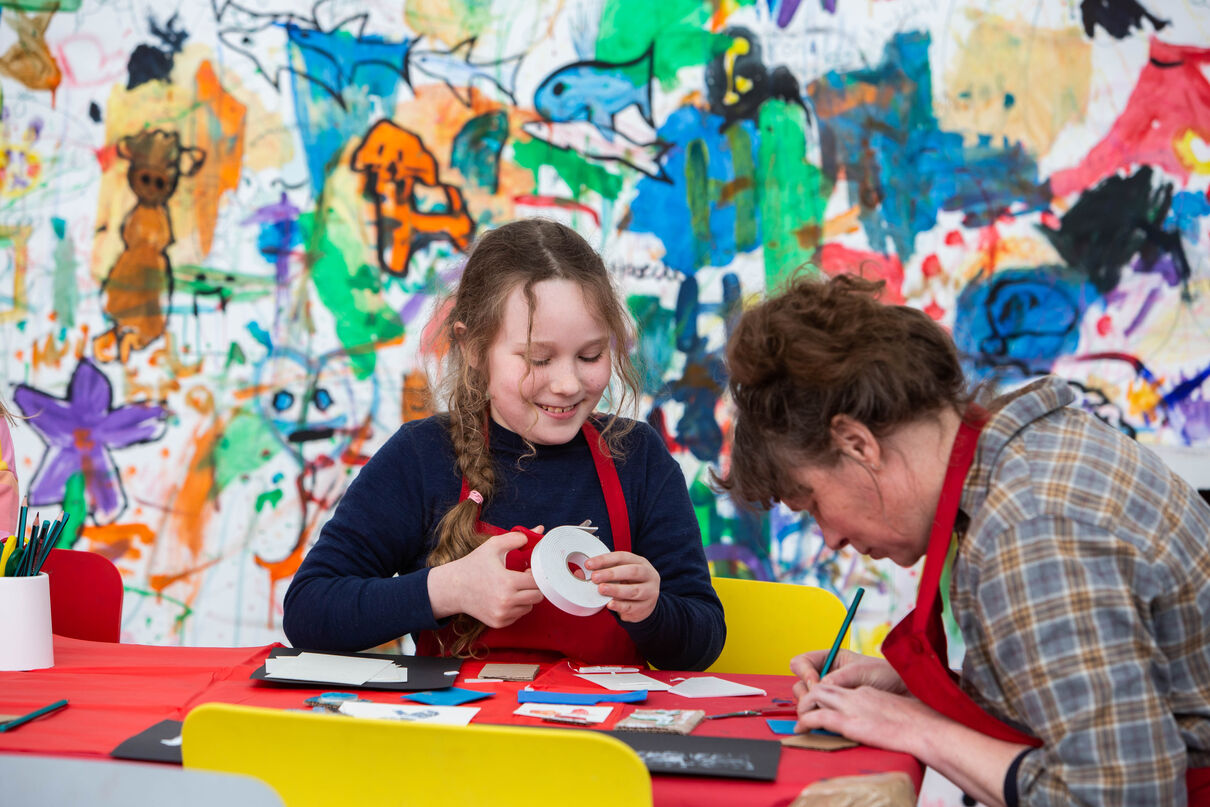 Parent and child making art together in Gallery 1 as part of Spring Holiday Pop-up